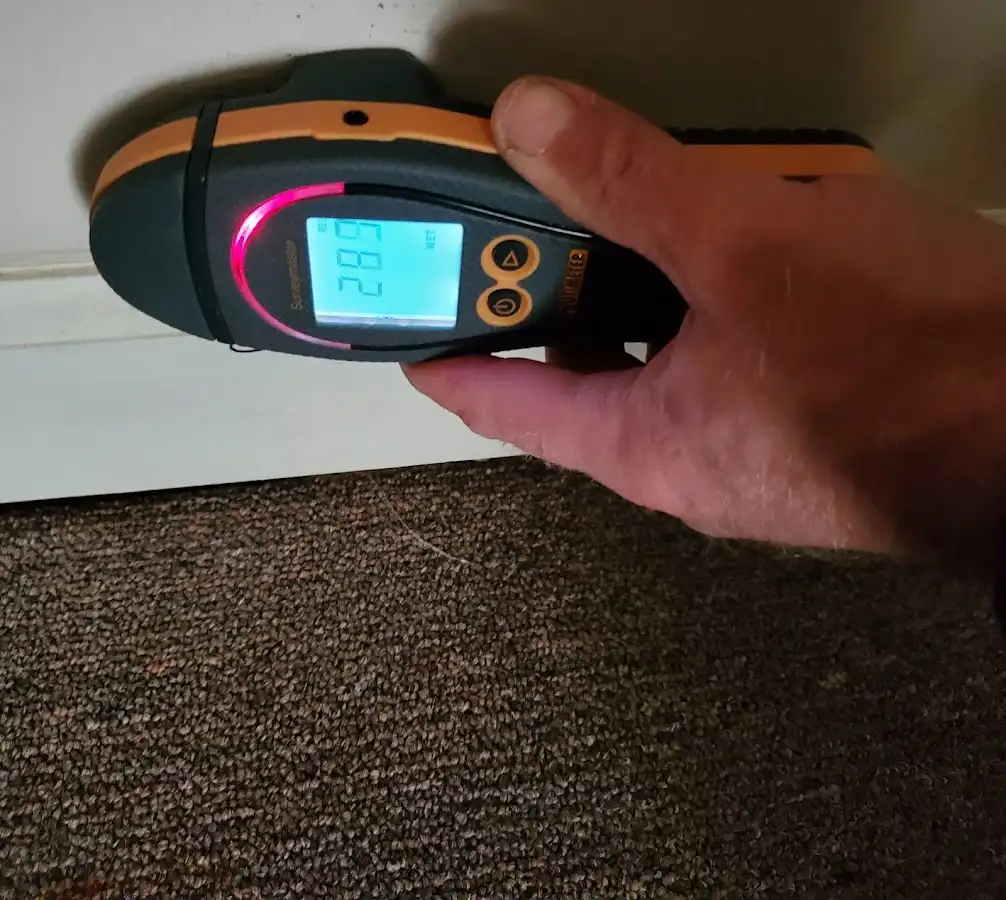 Moisture detection at baseboard during Storm Damage Restoration in Altoona